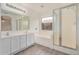 Bright bathroom featuring double sink vanity, soaking tub, and a separate shower at 7413 N 67Th Dr, Glendale, AZ 85303