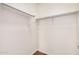 Spacious walk-in closet featuring a clothing rod, hardwood floors, and neutral paint at 7413 N 67Th Dr, Glendale, AZ 85303