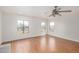 A light filled living room with hardwood floors, neutral paint, and multiple windows at 7413 N 67Th Dr, Glendale, AZ 85303