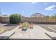 Outdoor seating area with colorful chairs, surrounded by a well-maintained landscape and mature trees at 7421 S 25Th Ln, Phoenix, AZ 85041