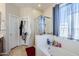 Bright bathroom featuring a soaking tub, glass shower, and large window at 7421 S 25Th Ln, Phoenix, AZ 85041