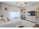 Bedroom featuring a ceiling fan, hardwood floors, and a large window at 7421 S 25Th Ln, Phoenix, AZ 85041