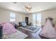 Bright bedroom with a ceiling fan, black rug, and a glass sliding door leading to a balcony at 7421 S 25Th Ln, Phoenix, AZ 85041