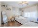 Comfortable bedroom featuring soft, neutral colors, a ceiling fan, and hardwood floors at 7421 S 25Th Ln, Phoenix, AZ 85041