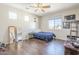 Bedroom with a ceiling fan, hardwood floors, and three windows at 7421 S 25Th Ln, Phoenix, AZ 85041