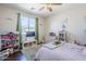 Cozy bedroom with hardwood floors, green curtains, and a window at 7421 S 25Th Ln, Phoenix, AZ 85041