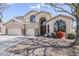 Expansive desert home featuring a 3-car garage, arched windows, neutral stucco and manicured landscaping at 7421 S 25Th Ln, Phoenix, AZ 85041