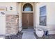 Charming front door with decorative stone accents and manicured landscaping at 7421 S 25Th Ln, Phoenix, AZ 85041