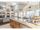 Open kitchen view with granite countertops, neutral color scheme, and views of the living area at 7421 S 25Th Ln, Phoenix, AZ 85041