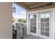 Balcony view featuring a stainless steel gas grill and French doors leading to the interior at 7675 E Mcdonald Dr # 225, Scottsdale, AZ 85250