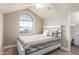 Bright bedroom featuring a unique arched window, ceiling fan, and access to the ensuite bathroom at 7675 E Mcdonald Dr # 225, Scottsdale, AZ 85250