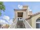 Close up of the two-story home, showcasing the stairway to the front door and unit number at 7675 E Mcdonald Dr # 225, Scottsdale, AZ 85250