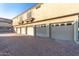 View of garages featuring multiple units with individual doors and a brick-paved driveway at 7675 E Mcdonald Dr # 225, Scottsdale, AZ 85250