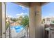 Balcony view of the community pool featuring lounge chairs, tables and neatly landscaped grounds at 7675 E Mcdonald Dr # 225, Scottsdale, AZ 85250