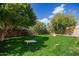 Lush backyard featuring cornhole boards and mature trees at 7693 E Via Del Sol Dr, Scottsdale, AZ 85255