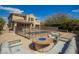 Inviting backyard featuring a fenced pool, lounge chairs, and fire pit with seating at 7693 E Via Del Sol Dr, Scottsdale, AZ 85255