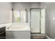 Bathroom featuring a white tub, glass shower, and neutral paint, with a window providing natural light at 7693 E Via Del Sol Dr, Scottsdale, AZ 85255