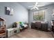 Cozy bedroom with a ceiling fan, play kitchen, lots of toys, and a window with natural light at 7693 E Via Del Sol Dr, Scottsdale, AZ 85255