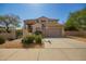 Charming two-story home featuring a wide driveway, desert landscaping, and a welcoming facade at 7693 E Via Del Sol Dr, Scottsdale, AZ 85255