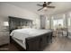 Spacious main bedroom featuring hardwood floors, a ceiling fan, and a decorative desk in natural lighting at 7693 E Via Del Sol Dr, Scottsdale, AZ 85255