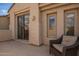 Neutral outdoor patio with sliding glass doors and wicker patio furniture at 7693 E Via Del Sol Dr, Scottsdale, AZ 85255