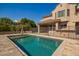 Backyard view of pool with a safety fence, patio, and an outdoor seating area at 7693 E Via Del Sol Dr, Scottsdale, AZ 85255