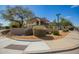 Corner lot showcasing desert landscaping with a glimpse of the two-story home at 7693 E Via Del Sol Dr, Scottsdale, AZ 85255