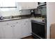 Kitchen featuring white cabinetry, stainless steel oven, and sink with window at 7807 E Main St # B-19, Mesa, AZ 85207