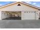 A well-lit 3 car garage with 2 bays visible, a workbench and ample space for vehicles and projects at 825 N Sierra Vista Dr, Wickenburg, AZ 85390