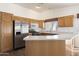 Well-equipped kitchen featuring stainless steel appliances, wooden cabinets and an island at 825 N Sierra Vista Dr, Wickenburg, AZ 85390