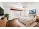 Comfortable main bedroom with a stylish ceiling fan, great natural light and hardwood floors at 825 N Sierra Vista Dr, Wickenburg, AZ 85390