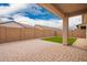 The covered back patio features a brick floor and small artificial turf area, great for entertaining at 8957 W Palo Verde Dr, Glendale, AZ 85305