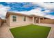 The backyard features a small patch of artificial turf and a stone-paved patio at 8957 W Palo Verde Dr, Glendale, AZ 85305