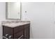 Bathroom vanity featuring granite countertops, modern fixtures, and a decorative mirror at 8957 W Palo Verde Dr, Glendale, AZ 85305