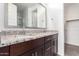 Bathroom with double sink vanity, granite countertops, wood cabinets and walk-in closet at 8957 W Palo Verde Dr, Glendale, AZ 85305