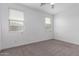 Neutral bedroom featuring large windows with blinds, and neutral carpet at 8957 W Palo Verde Dr, Glendale, AZ 85305