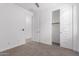 Bright bedroom with carpet, ceiling fan, closet, and white door at 8957 W Palo Verde Dr, Glendale, AZ 85305