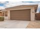 Single-story home showcasing the two-car garage and desert landscaping at 8957 W Palo Verde Dr, Glendale, AZ 85305