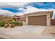 Single-story home featuring a two-car garage and desert landscaping at 8957 W Palo Verde Dr, Glendale, AZ 85305