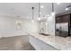 Kitchen island featuring granite countertops, pendant lighting, stainless steel dishwasher, and tile flooring at 8957 W Palo Verde Dr, Glendale, AZ 85305