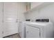 Laundry room with appliances, door to exterior, and shelving at 8957 W Palo Verde Dr, Glendale, AZ 85305