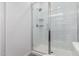 Bright shower stall featuring subway tile, glass door, and convenient corner shelving at 8957 W Palo Verde Dr, Glendale, AZ 85305