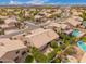 Community aerial view, featuring lush landscaping, pools, and mountain views at 9104 E Hillery Dr, Scottsdale, AZ 85260