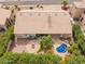 Beautiful aerial view of the home with a sparkling pool, covered patio, and a charming fire pit area surrounded by lush landscaping at 9104 E Hillery Dr, Scottsdale, AZ 85260