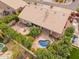 Stunning aerial view showcasing the backyard with a uniquely shaped pool, manicured landscaping, and a cozy outdoor seating area at 9104 E Hillery Dr, Scottsdale, AZ 85260