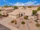 Aerial view of the home featuring a three-car garage and desert landscaping at 9104 E Hillery Dr, Scottsdale, AZ 85260