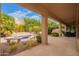 Covered patio featuring a small pool, bench, and beautifully landscaped backyard perfect for relaxing at 9104 E Hillery Dr, Scottsdale, AZ 85260