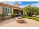 Backyard with a stone fire pit and outdoor seating area at 9104 E Hillery Dr, Scottsdale, AZ 85260