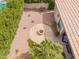 Aerial view of the backyard highlighting the fire pit area, landscaping, and covered patio with outdoor furniture at 9104 E Hillery Dr, Scottsdale, AZ 85260