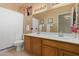 Well-lit bathroom features double sinks with vanity and a shower with white curtain at 9104 E Hillery Dr, Scottsdale, AZ 85260